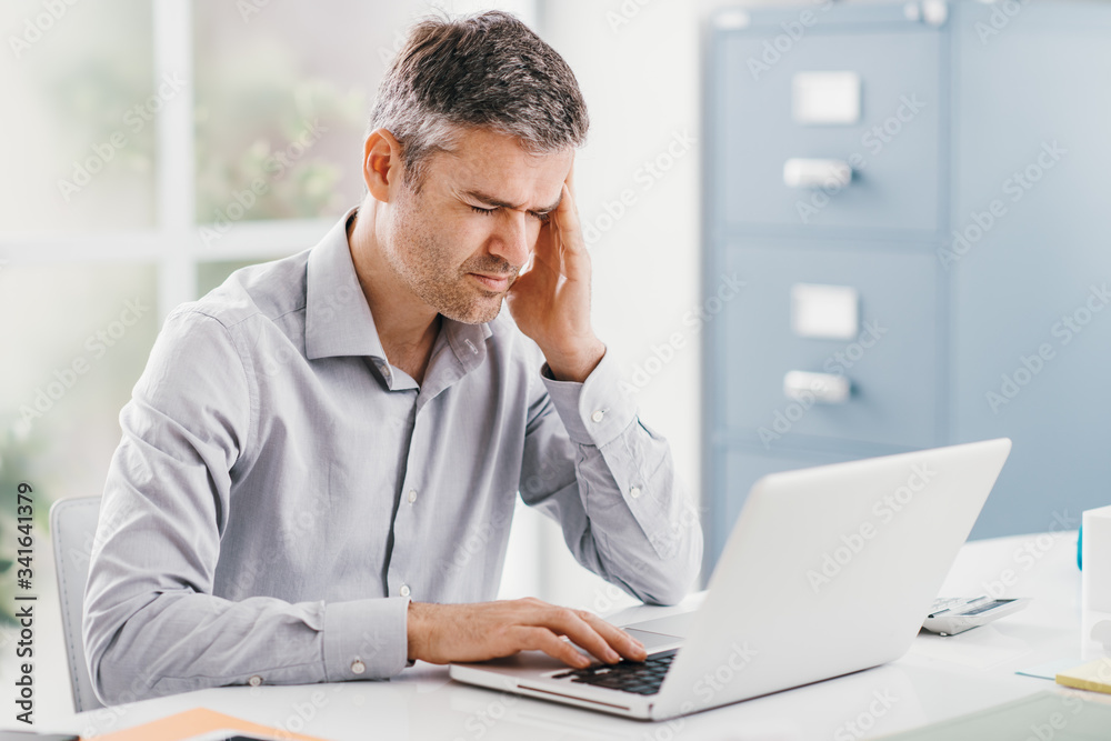 Stressed businessman with headache Stressed businessman with headache