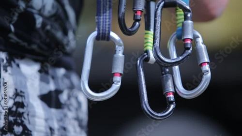 Five large metal rock climbing carabiners.