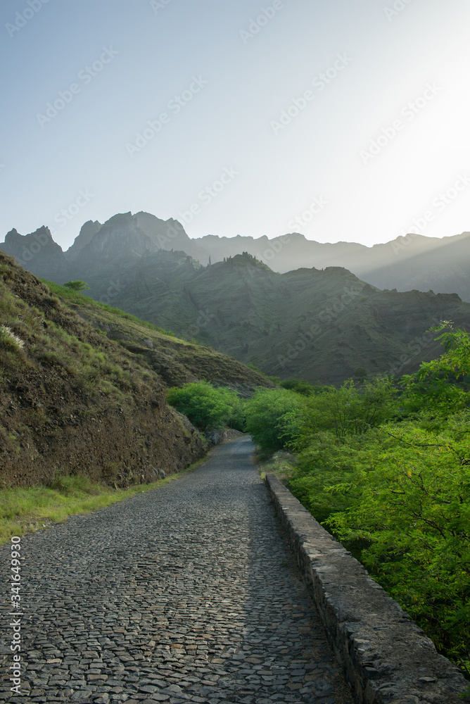 Cobblestone road with sunny mountains in the background among nature in Sao Vicente in Cape Verde on 01/10/2017