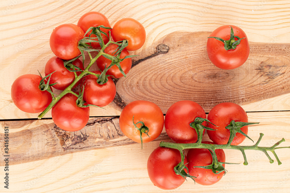 Lot of whole fresh red cherry tomato on wood Lot of whole fresh red cherry tomato on wood