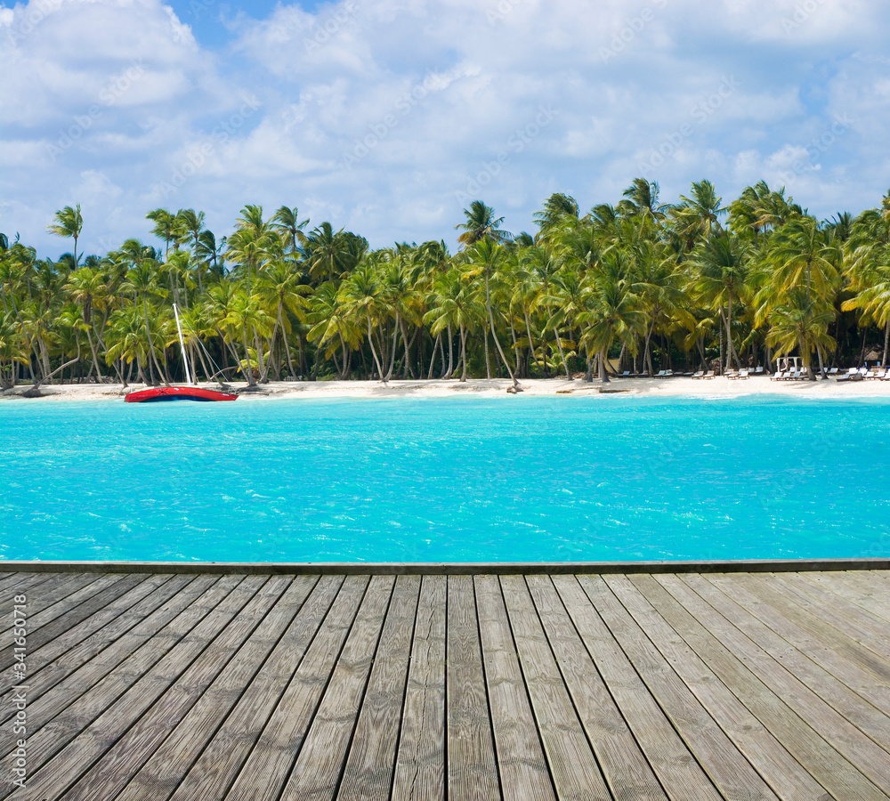 Empty wooden platform with tropical beach in Caribbean sea in the background, Saona island, Dominican Republic