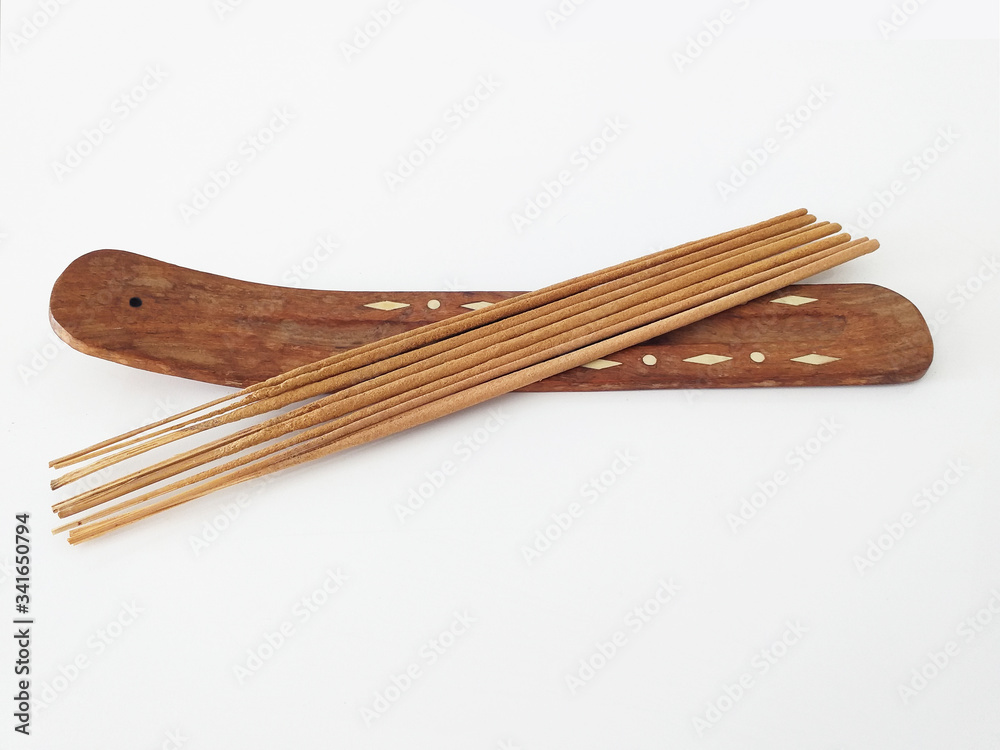 Aerial view of natural incense sticks on rectangular wooden censer isolated on white background. Aerial view of natural incense sticks on rectangular wooden censer isolated on white background.