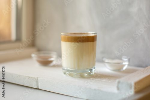 Dalgona coffee is a trendy drink from Korea. Popular whipped coffee with cold milk.