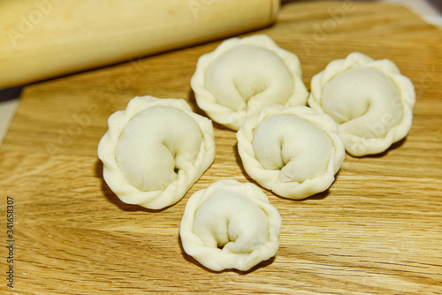 Five dumplings of round shape on the wooden deck.