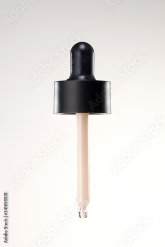 a cosmetic pipette with foundation cream.