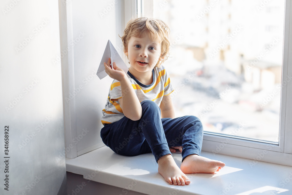 Boy sitting near window. Stay home concept, Coronavirus Covid-19 quarantine Boy sitting near window. Stay home concept, Coronavirus Covid-19 quarantine