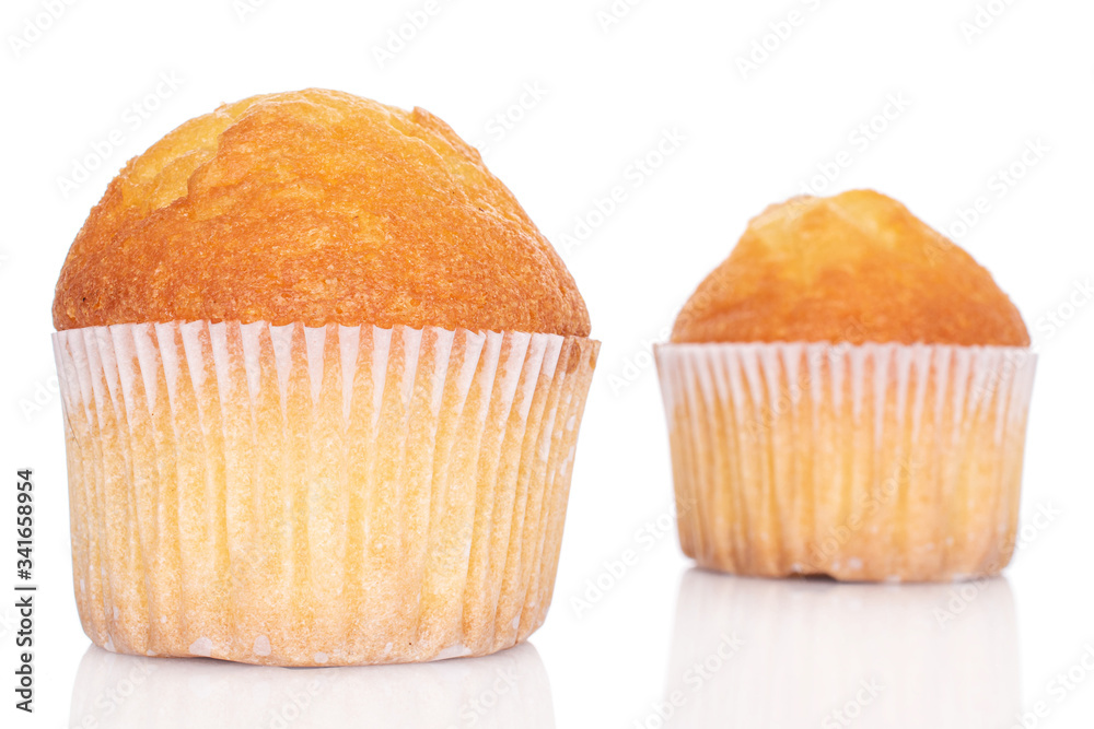 Group of two whole small baked muffin isolated on white Group of two whole small baked muffin isolated on white