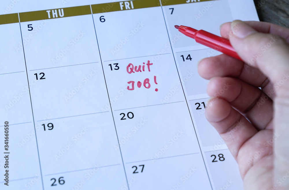 Quit job words written on table calendar with red marker Quit job words written on table calendar with red marker