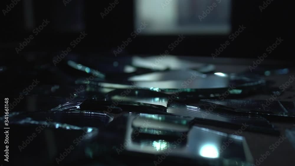 Glass and hands. Mirror broken on the table.