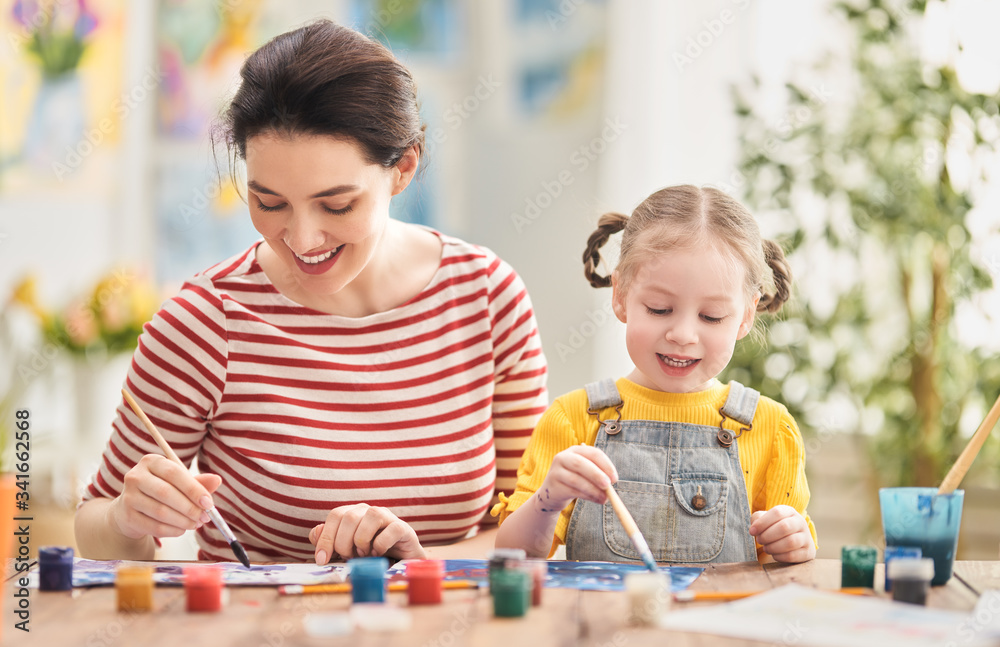 Happy family painting together. Happy family painting together.