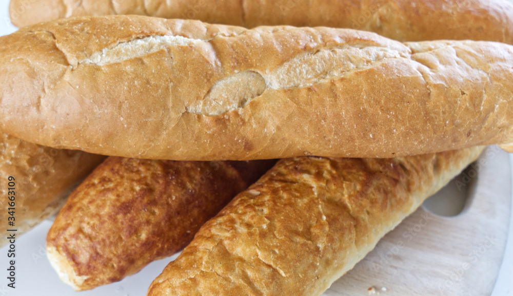 Fresh bread, french baton, tiger bread and small baguettes close up, with shallow depth of focus