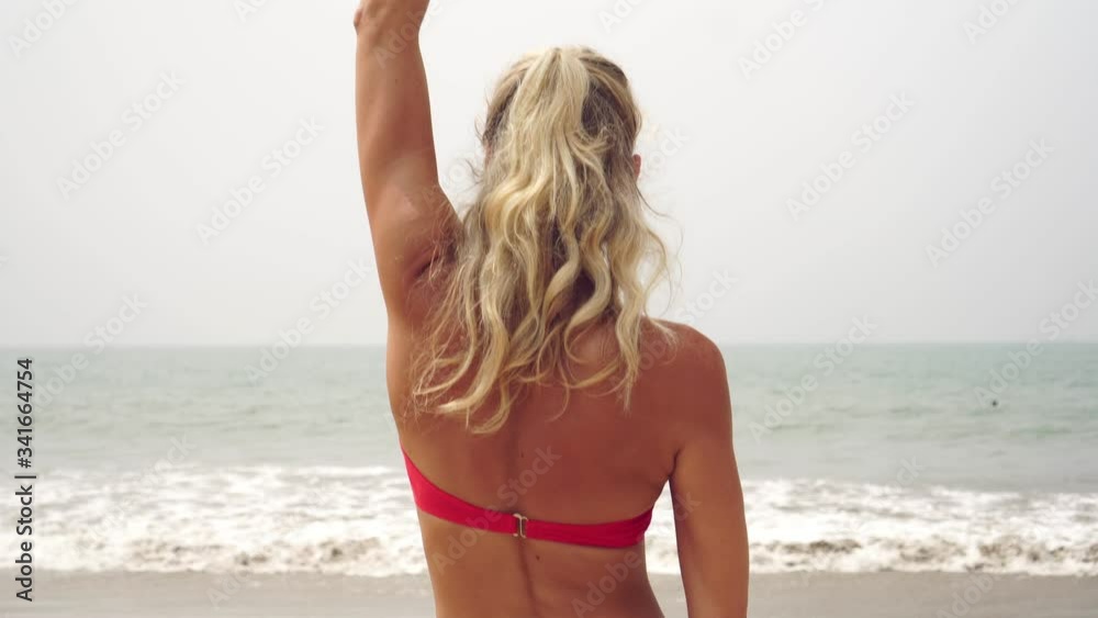 Beautiful young woman in a swimsuit practices yoga on a sandy beach Beautiful young woman in a swimsuit practices yoga on a sandy beach