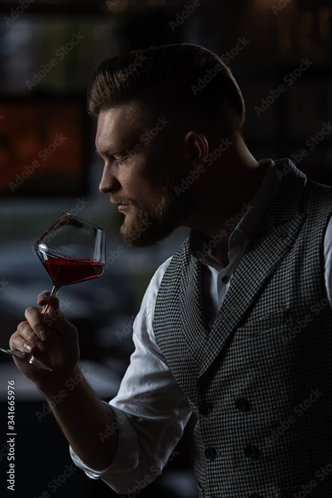 Professional sommelier man with a glass of red wine. Professional sommelier man with a glass of red wine.