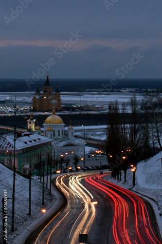 Nizhny Novgorod city at night. blurry car headlights. views of the Church and the stadium