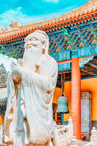 Statue of Confucius, the great Chinese philosopher in Temple of Confucius at Beijing.Focus on the background.