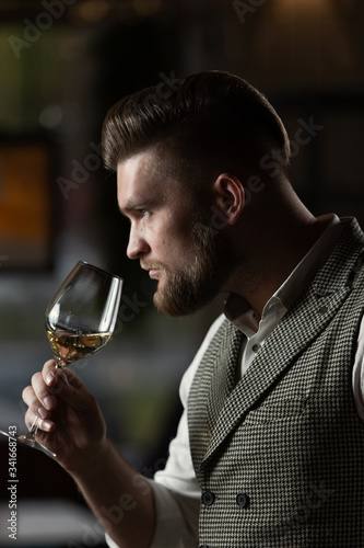Professional sommelier man with a glass of white wine.