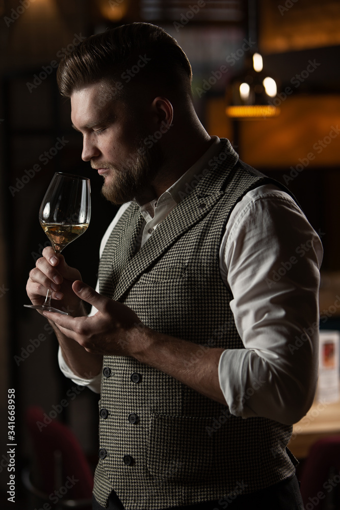 Professional sommelier man with a glass of white wine. Professional sommelier man with a glass of white wine.