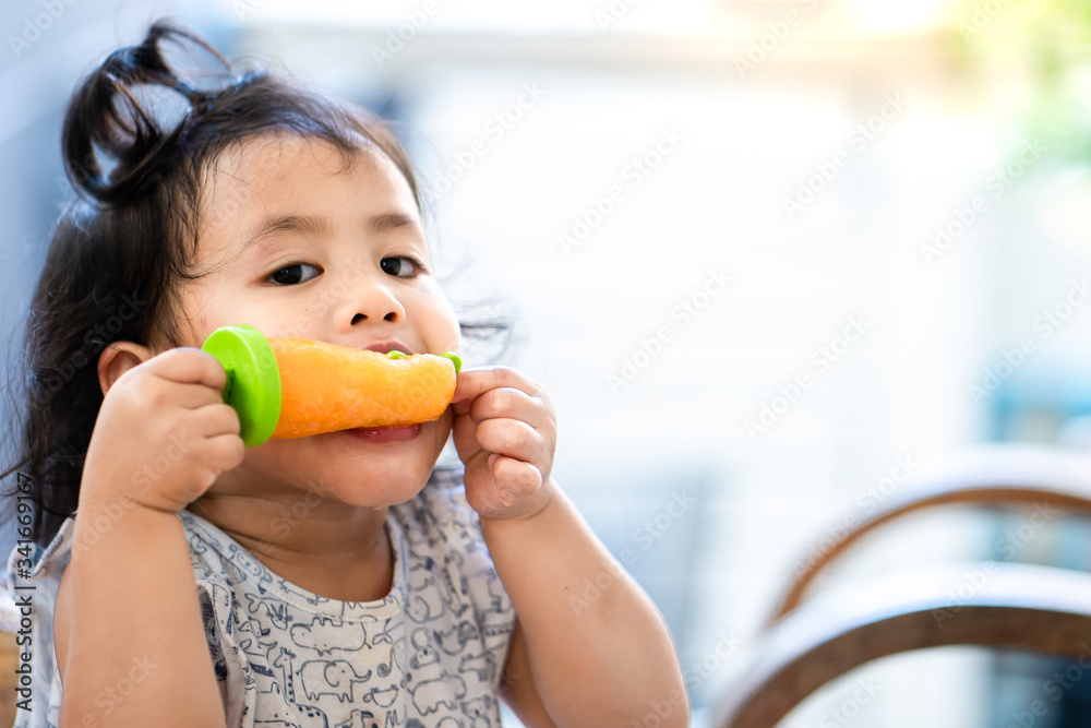 Cut little girl enjoy eating sorbet ice cream indoor. Cut little girl enjoy eating sorbet ice cream indoor.