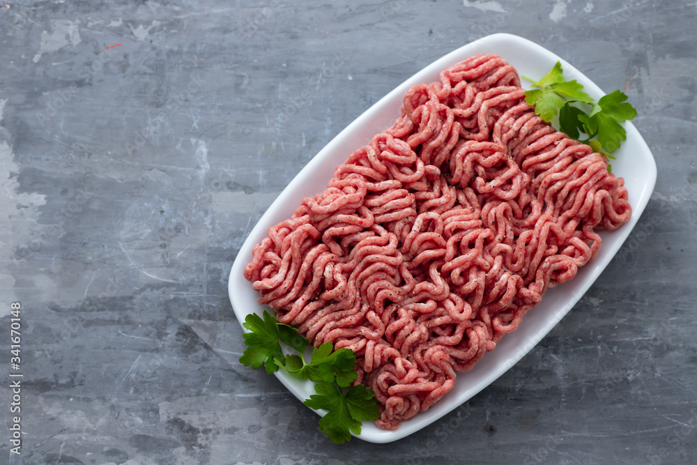 ground meat on white dish on ceramic background