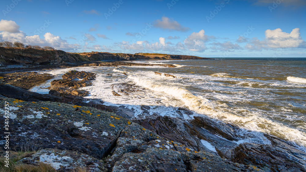 Waves Crashing on Howick's Rocky Shore, below the cliffs  at Howick and Cullernose Point on the Northumberland coast, AONB, just south of Craster