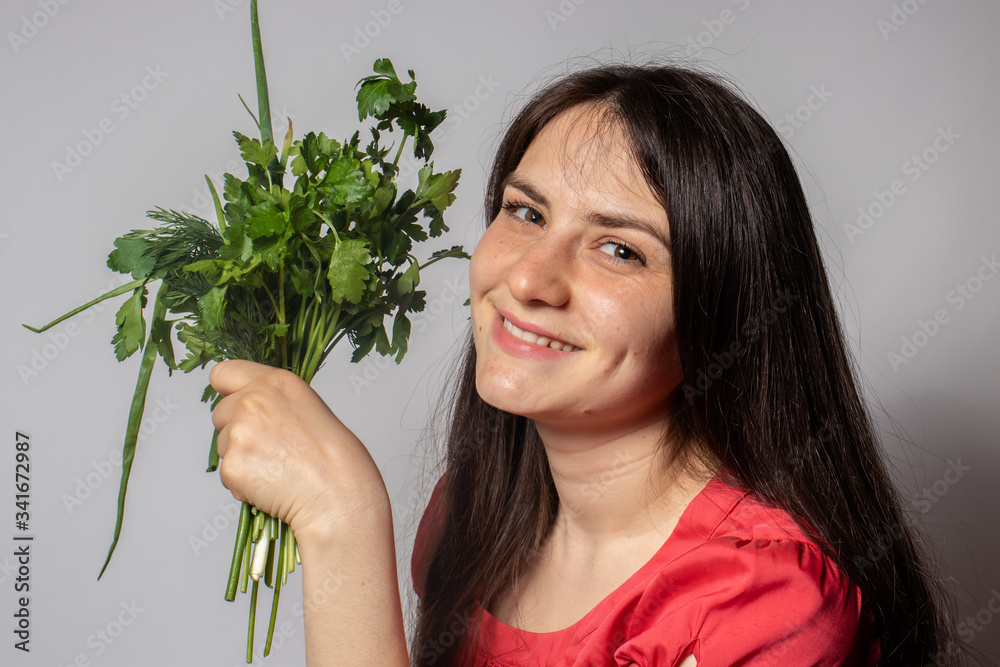 The girl holds parsley, dill and other herbs in her hand and smiles. Ketodiet, body detox, raw food diet, gluten-free diet, Ducane diet. The benefits of green vegetables for human health.
The girl holds parsley, dill and other herbs in her hand and smiles. Ketodiet, body detox, raw food diet, gluten-free diet, Ducane diet. The benefits of green vegetables for human health.