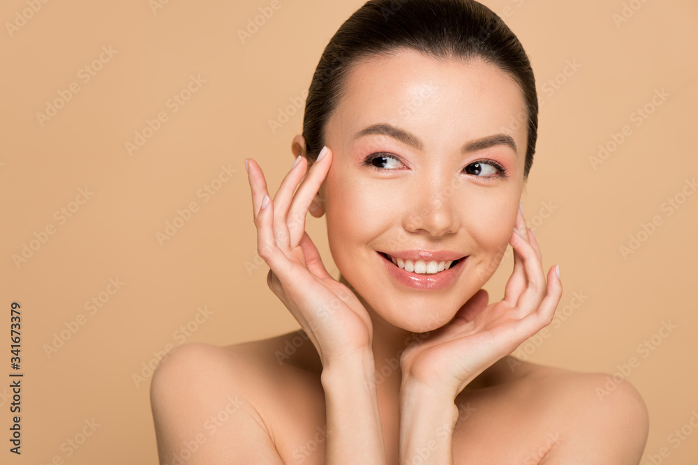 attractive smiling tender naked asian woman with perfect skin isolated on beige attractive smiling tender naked asian woman with perfect skin isolated on beige