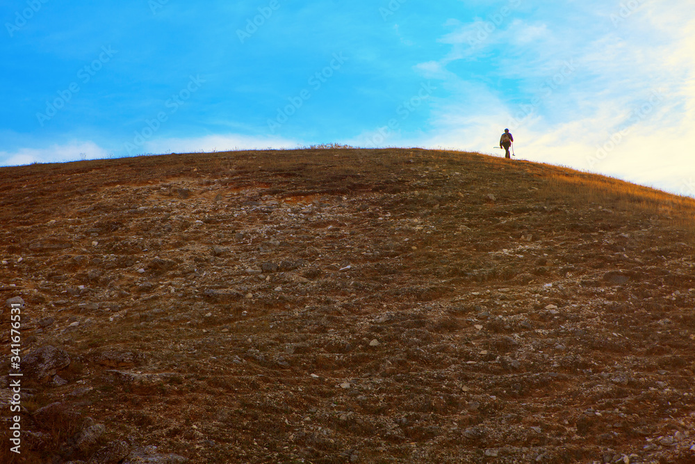 lone wanderer walks on a mountain