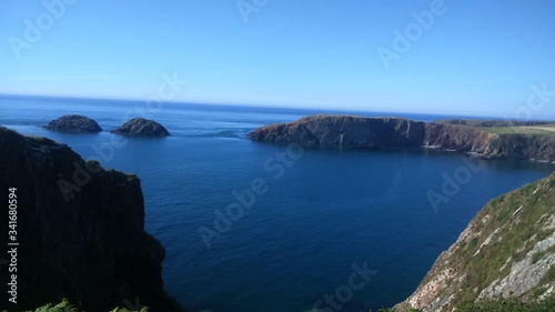 Scenic View Of Rocks And Sea Against Clear Blue Sky © rose bongyerire/EyeEm