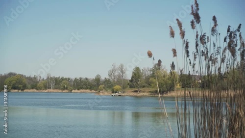 Lake shore with the small pier on the opposite side