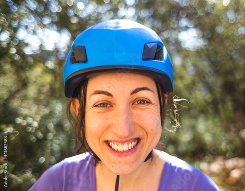 Portrait of a woman in a blue safety helmet. © zhukovvvlad