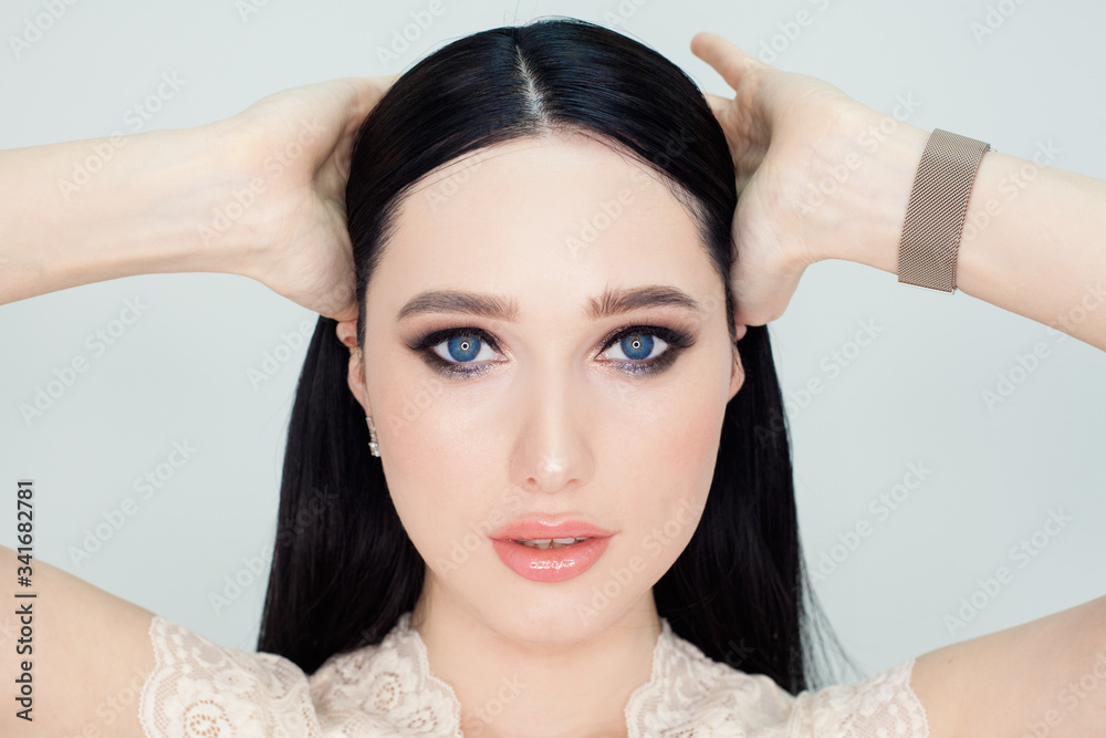 Fototapeta premium A clean face with young skin, a portrait of a woman on a white background. Concept photo for advertising facial cleansing products and creams with a lifting effect.