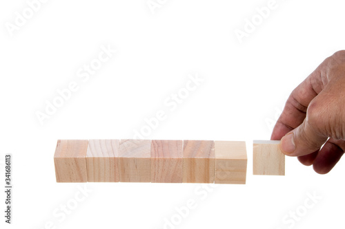 Hand holding blank wooden cubes with  white alarm clock . Business concept background, mock up, template