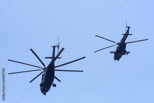 Russian military helicopters against the blue sky.