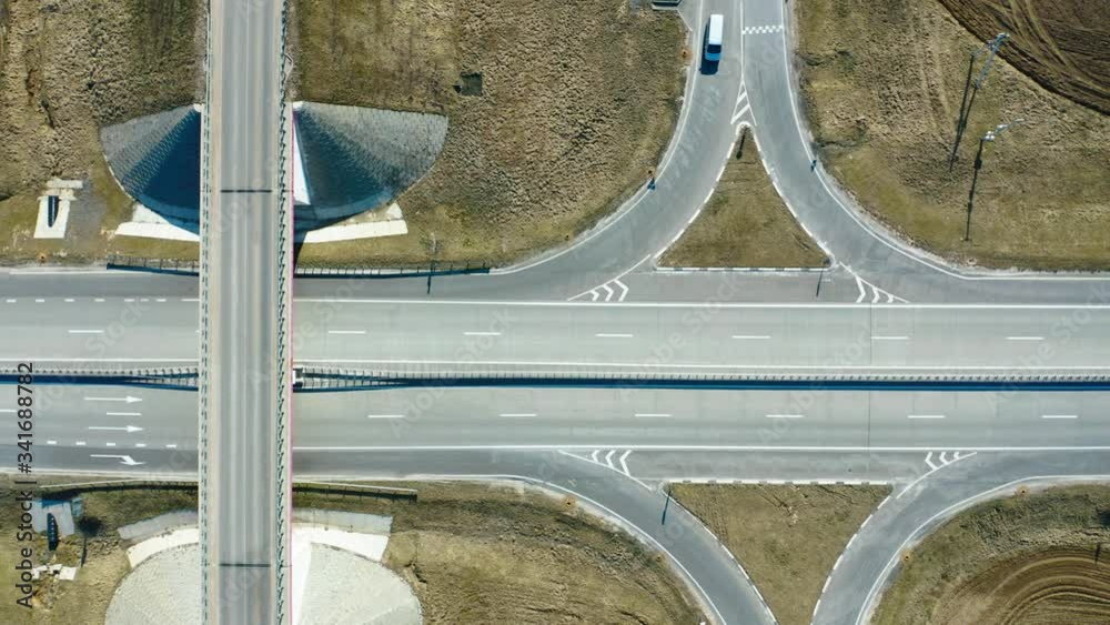 Aerial top down view on freeway road. Asphalt road between field. Spring, sunny day.
Aerial top down view on freeway road. Asphalt road between field. Spring, sunny day.