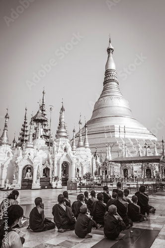 Yangon  Myanmar     March 2018  Buddhist monks praying in a beautiful Yangon temple  black and white photos