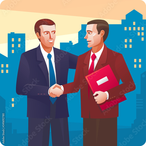 Conclusion of the transaction. Two smiling businessman in suits are handshaking.