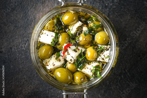 Obraz na plátne Feta with olives marinated in olive oil with spices