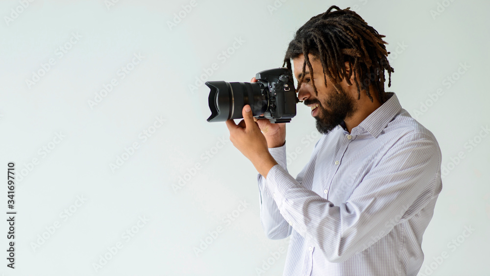 Medium shot man taking pictures. Black man in photography studio. Medium shot man taking pictures. Black man in photography studio.