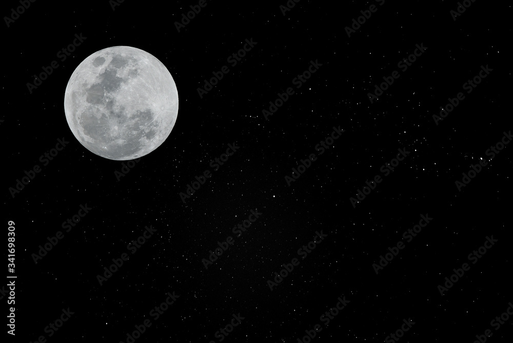 Full moon in the dark sky with many real stars.