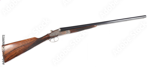Side-by-side double-barreled spanish hunting shotgun isolated on white background