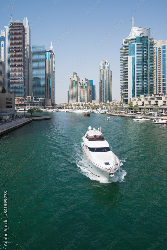 Dubai city skyline and marina with a private yacht  