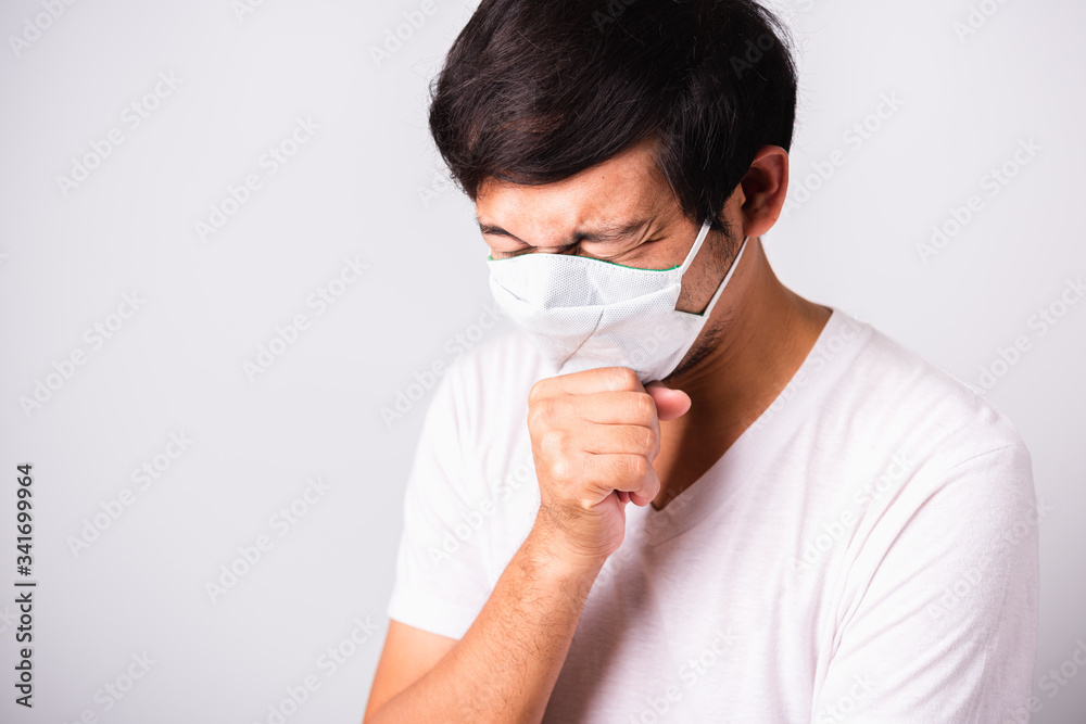 Man wearing surgical hygienic protective cloth face mask against coronavirus he sneeze Man wearing surgical hygienic protective cloth face mask against coronavirus he sneeze