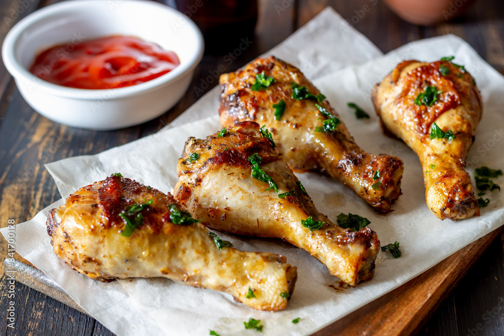 Chicken legs on a wooden background. Barbecue. Grill. American cuisine. Recipe. Rustic. Chicken legs on a wooden background. Barbecue. Grill. American cuisine. Recipe. Rustic.