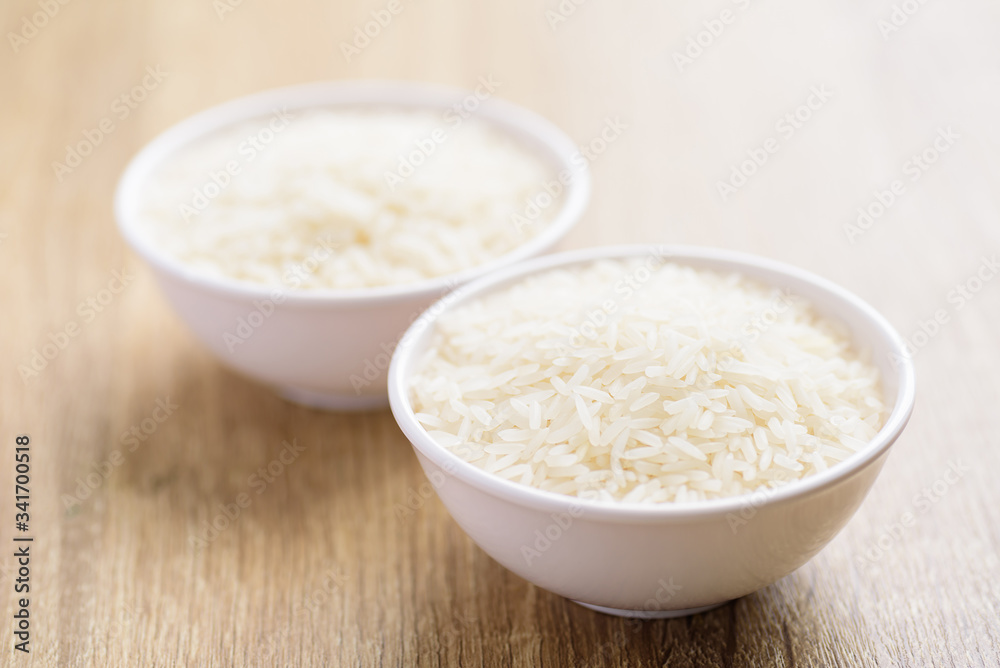 Organic Thai Jasmine rice grain in a bowl preparing for cooked Organic Thai Jasmine rice grain in a bowl preparing for cooked