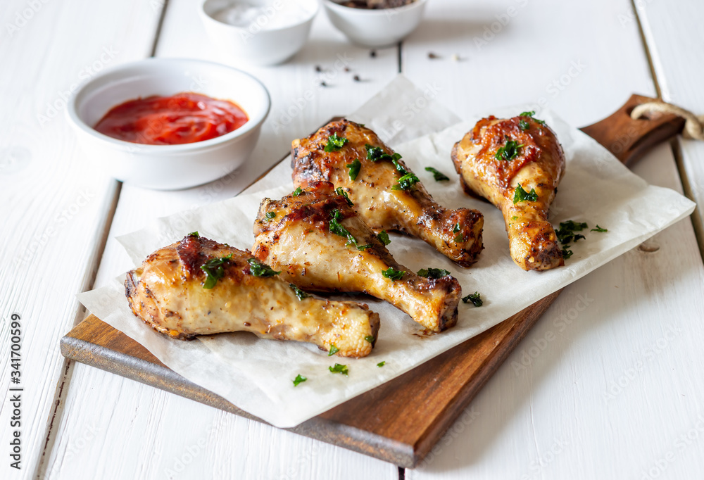 Chicken legs on a wooden background. Barbecue. Grill. American cuisine. Recipe. Rustic. Chicken legs on a wooden background. Barbecue. Grill. American cuisine. Recipe. Rustic.