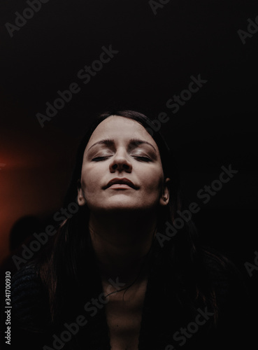 Portrait of a young woman meditating at home