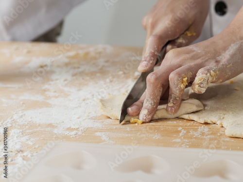 Asian chef preparing dough for pizza or bread on table, work lifestyle