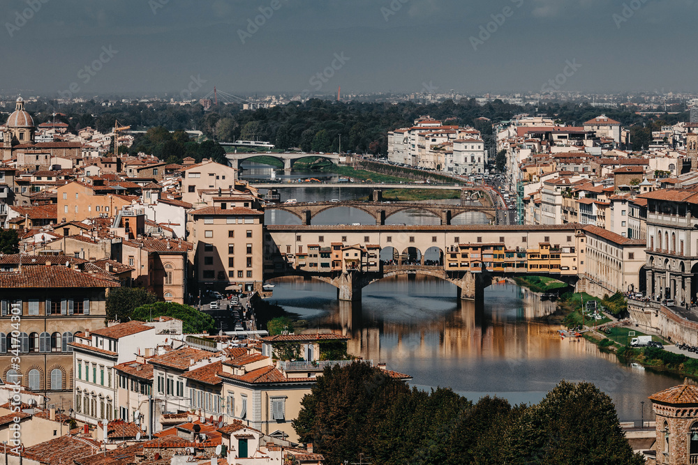 A bridge in Florence, located at the narrowest point of the Arno River. Daytime landscape in Italy.