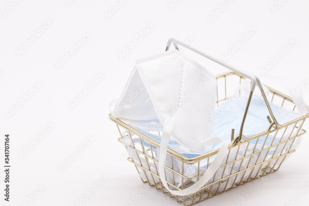 Obraz premium medical mask for protection against coronavirus. Medical respiratory bandage face in shopping cart on white background. prevention of the spread of virus and pandemic COVID-19. concept price face mask