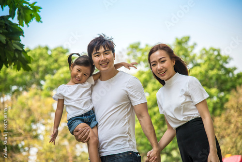 Portrait Of Happy Asian Family In Garden